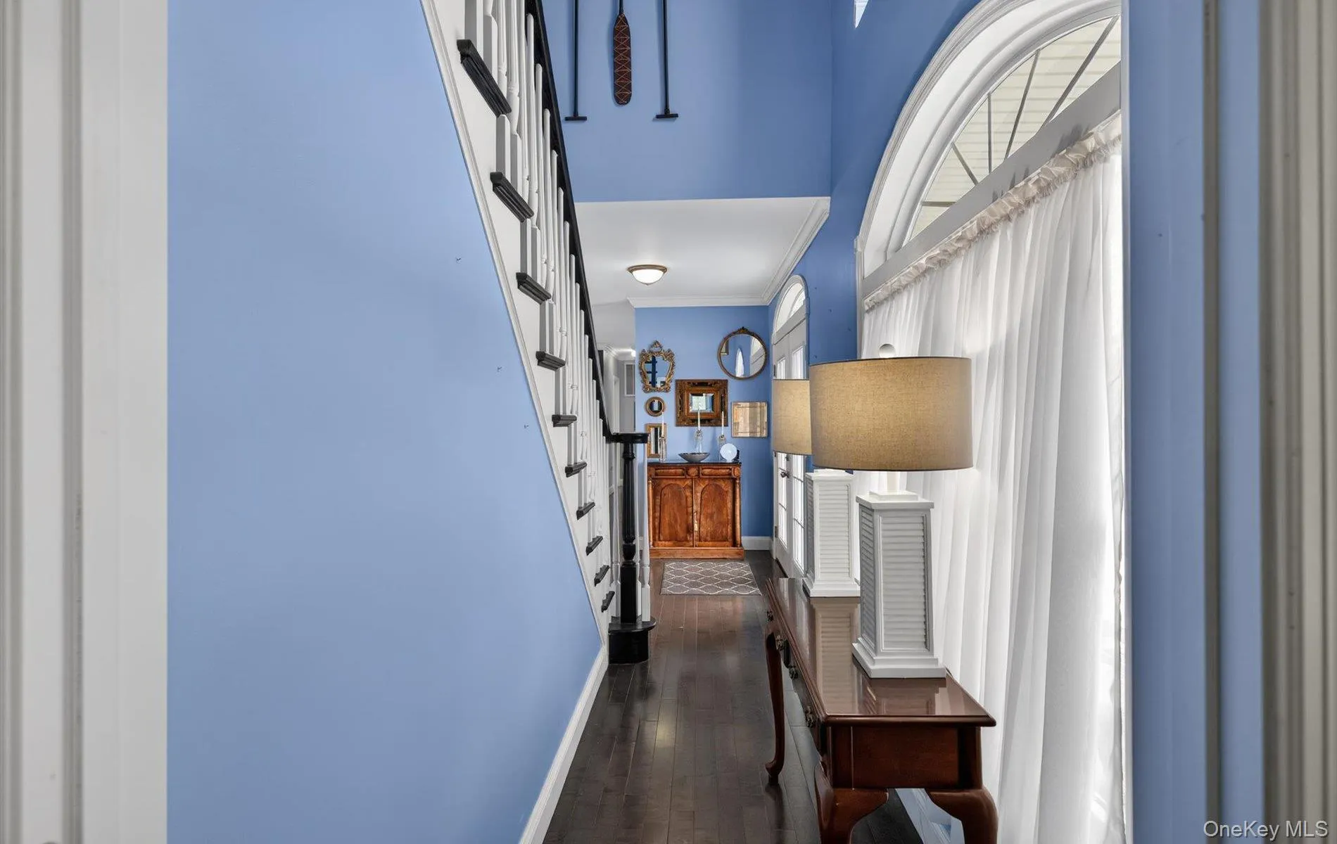 Corridor with dark wood-type flooring and crown molding Corridor with dark wood-type flooring and crown molding