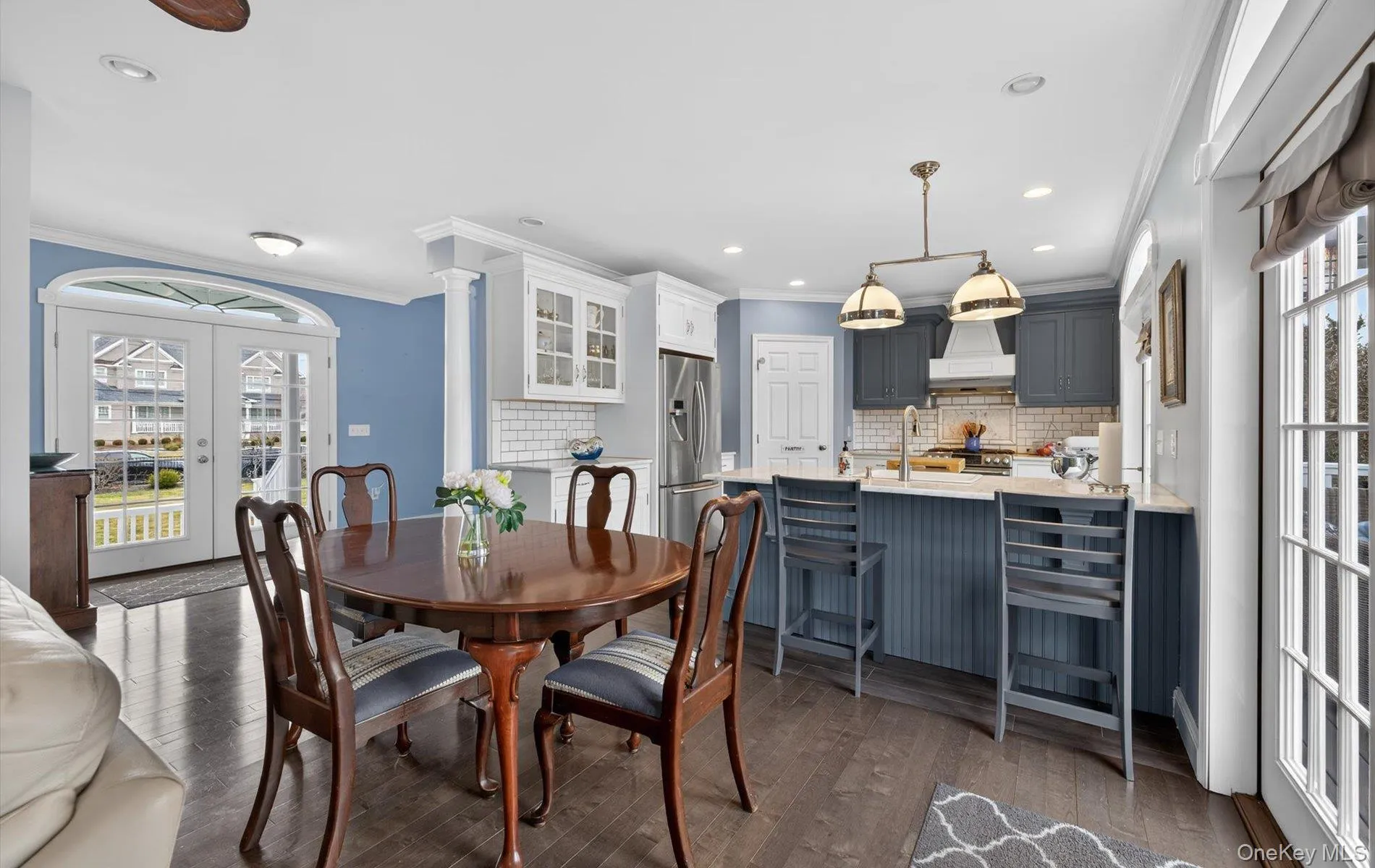 Dining area featuring french doors, crown molding, dark wood-style floors, and recessed lighting Dining area featuring french doors, crown molding, dark wood-style floors, and recessed lighting
