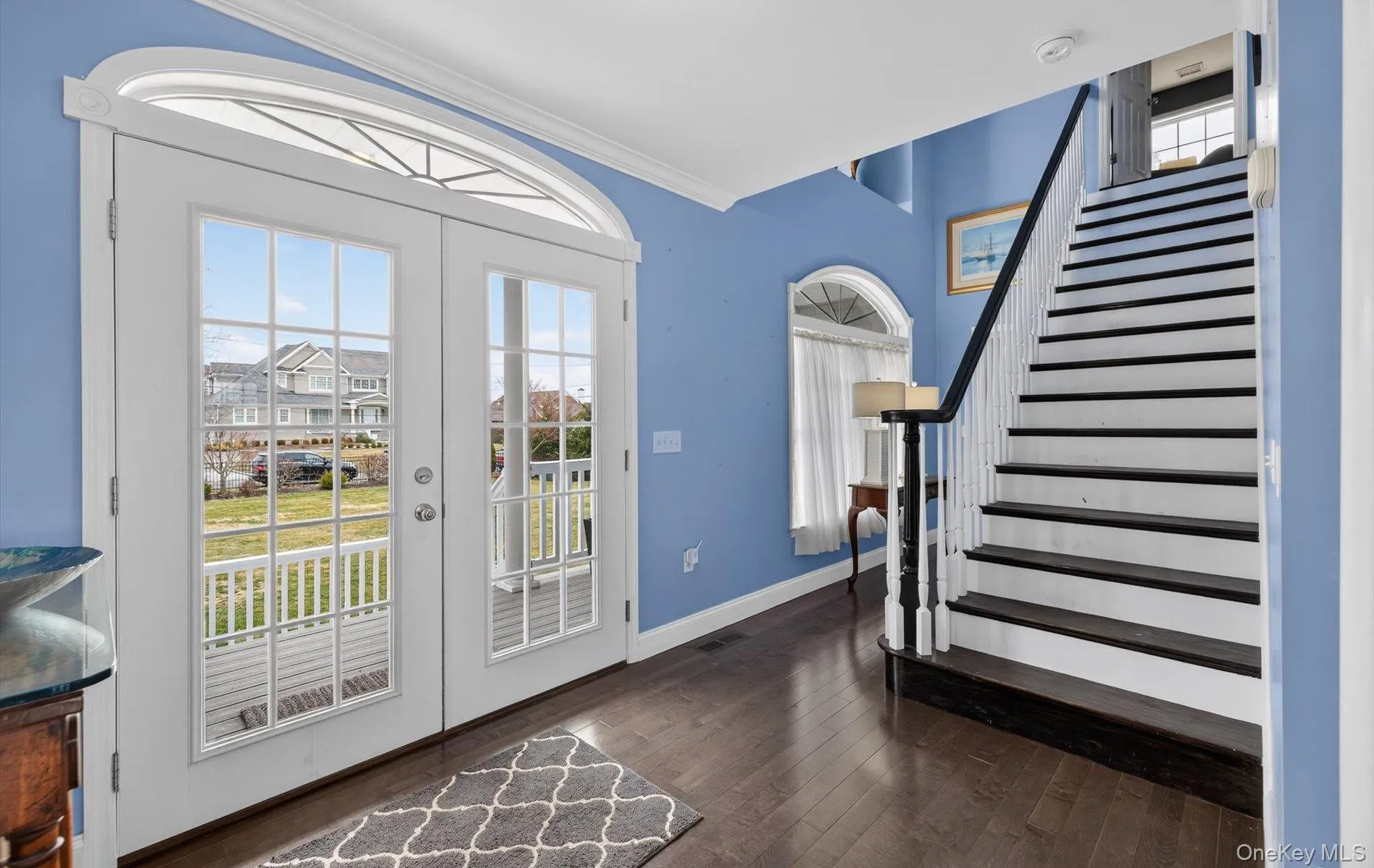 Entryway with hardwood / wood-style floors, crown molding, and french doors Entryway with hardwood / wood-style floors, crown molding, and french doors