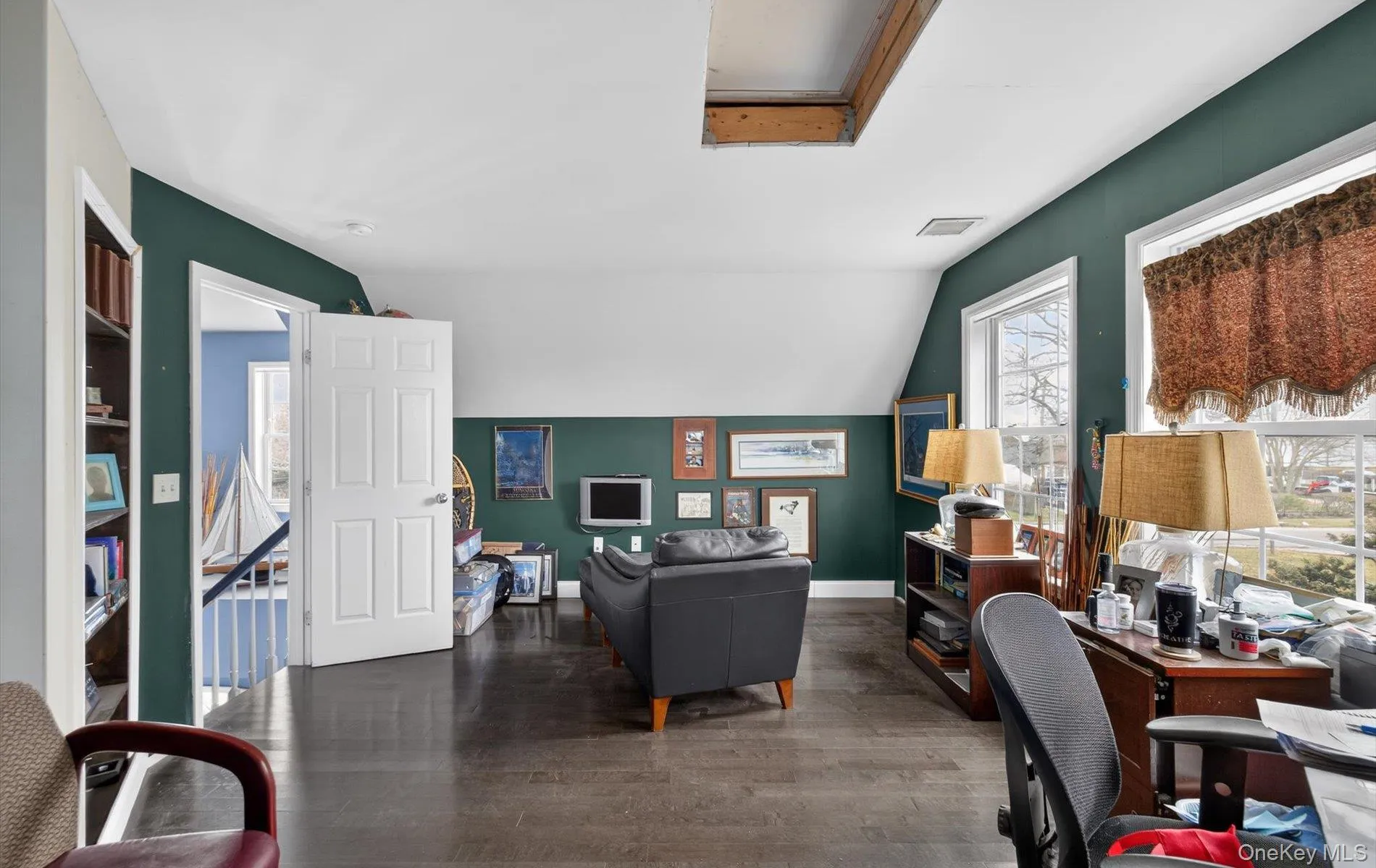 Office featuring lofted ceiling and wood finished floors Office featuring lofted ceiling and wood finished floors