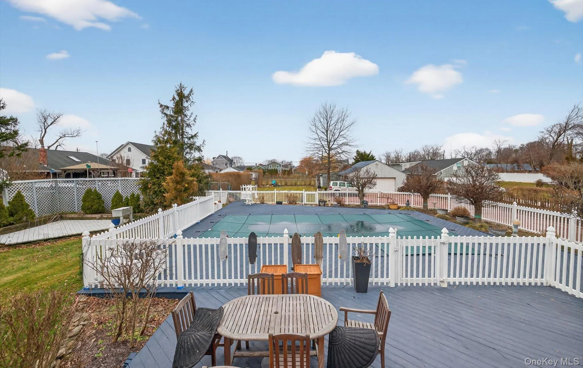 View of pool featuring a residential view, outdoor dining space, and a wooden deck View of pool featuring a residential view, outdoor dining space, and a wooden deck