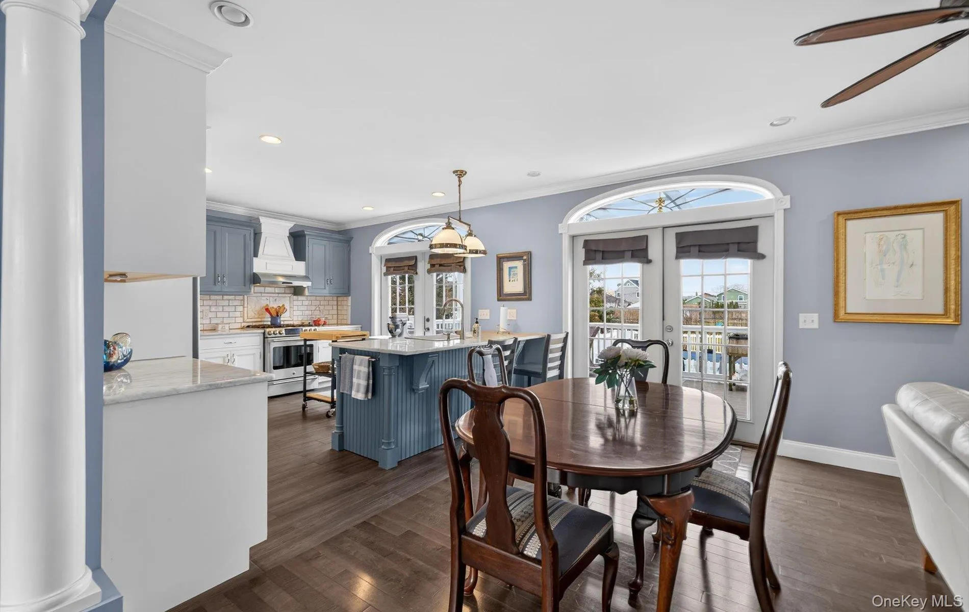 Dining area with french doors, ornamental molding, dark wood-style flooring, recessed lighting, and a ceiling fan Dining area with french doors, ornamental molding, dark wood-style flooring, recessed lighting, and a ceiling fan