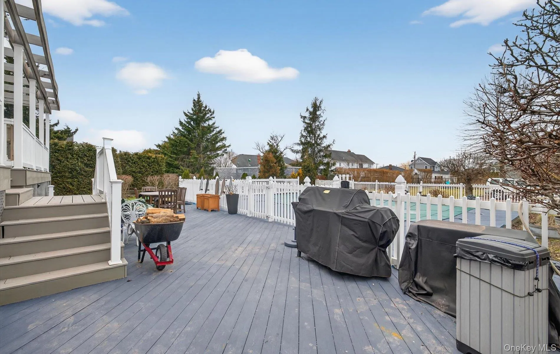 Deck with grilling area and a residential view Deck with grilling area and a residential view