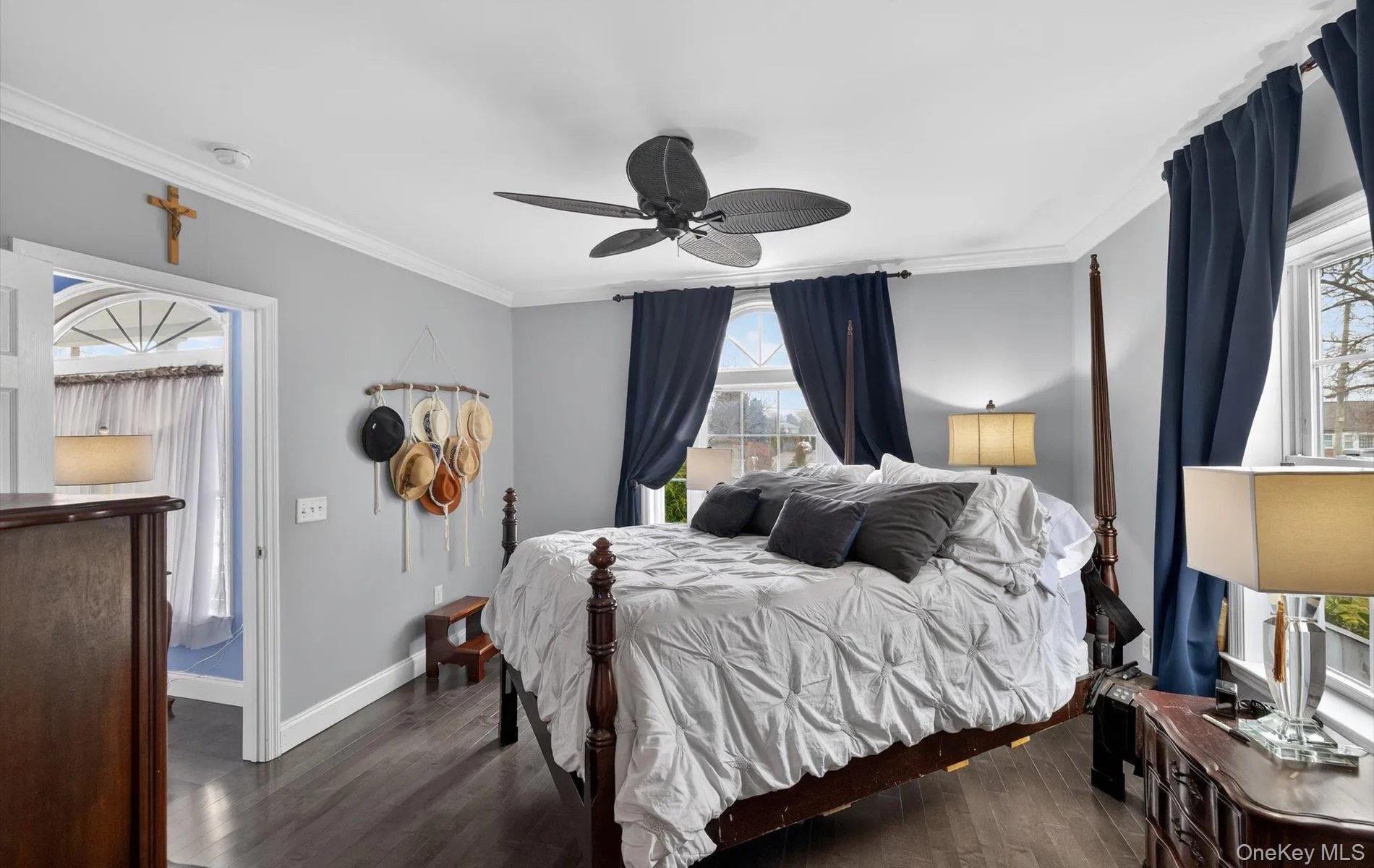 Bedroom with ornamental molding, dark wood-style floors, and ceiling fan Bedroom with ornamental molding, dark wood-style floors, and ceiling fan