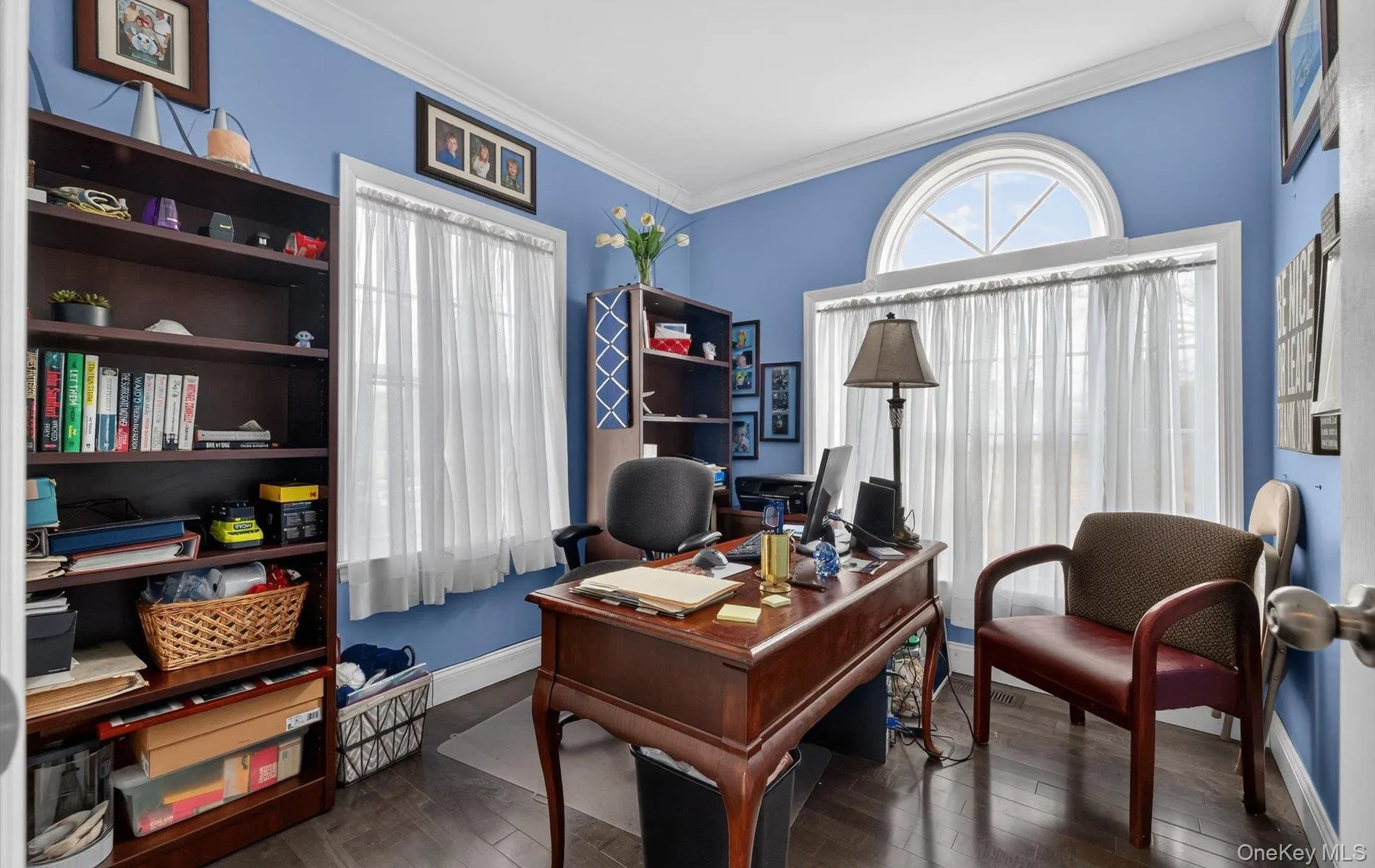 Office space with dark wood-style flooring and ornamental molding Office space with dark wood-style flooring and ornamental molding