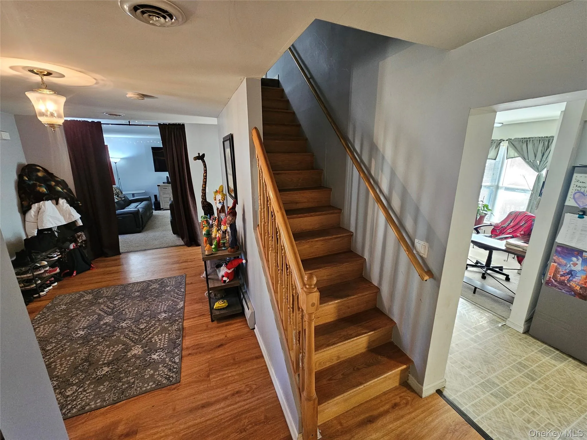 Staircase featuring wood finished floors Staircase featuring wood finished floors