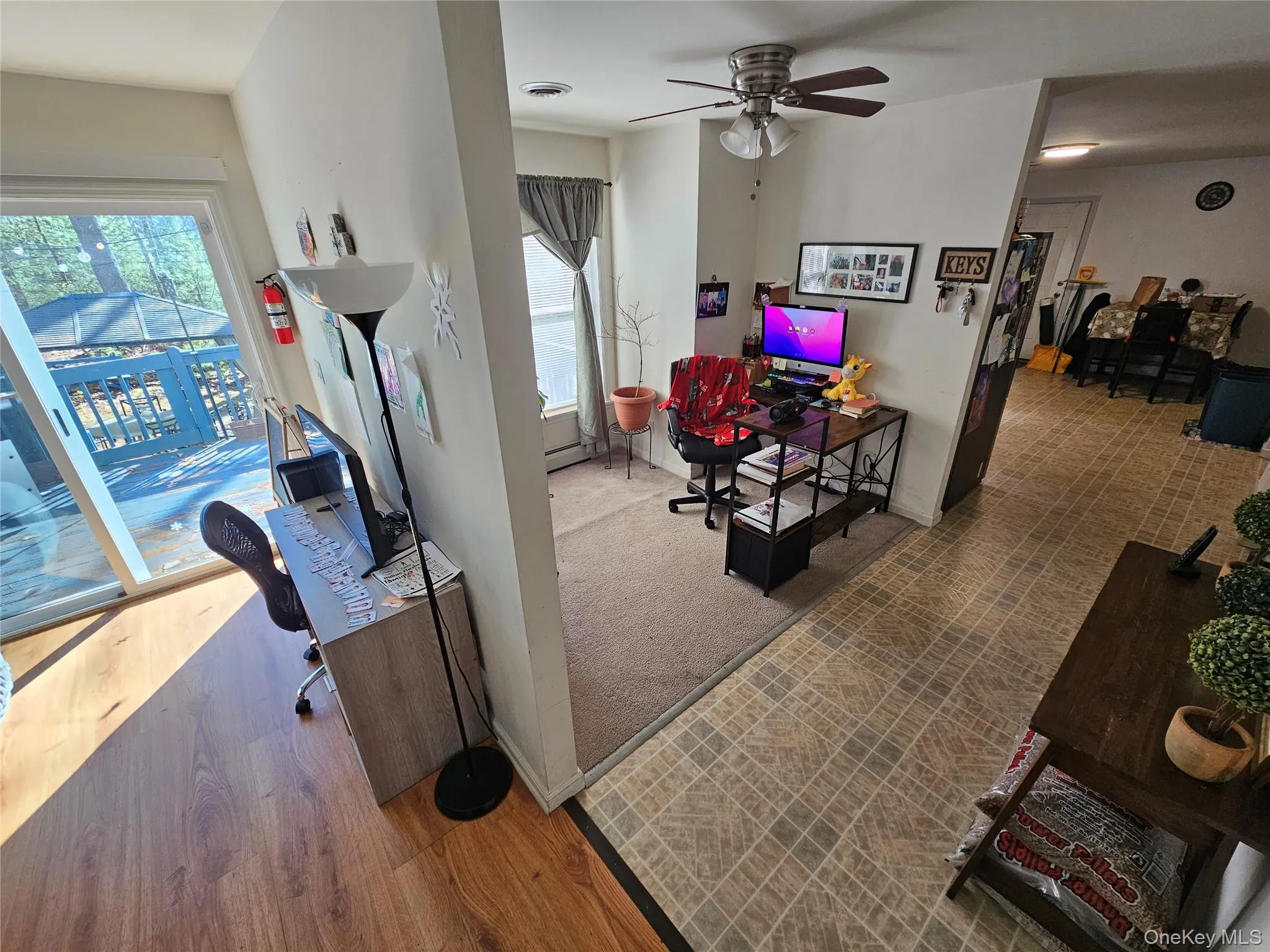 Family Room Divided to Office Space with a desk and ceiling fan Family Room Divided to Office Space with a desk and ceiling fan