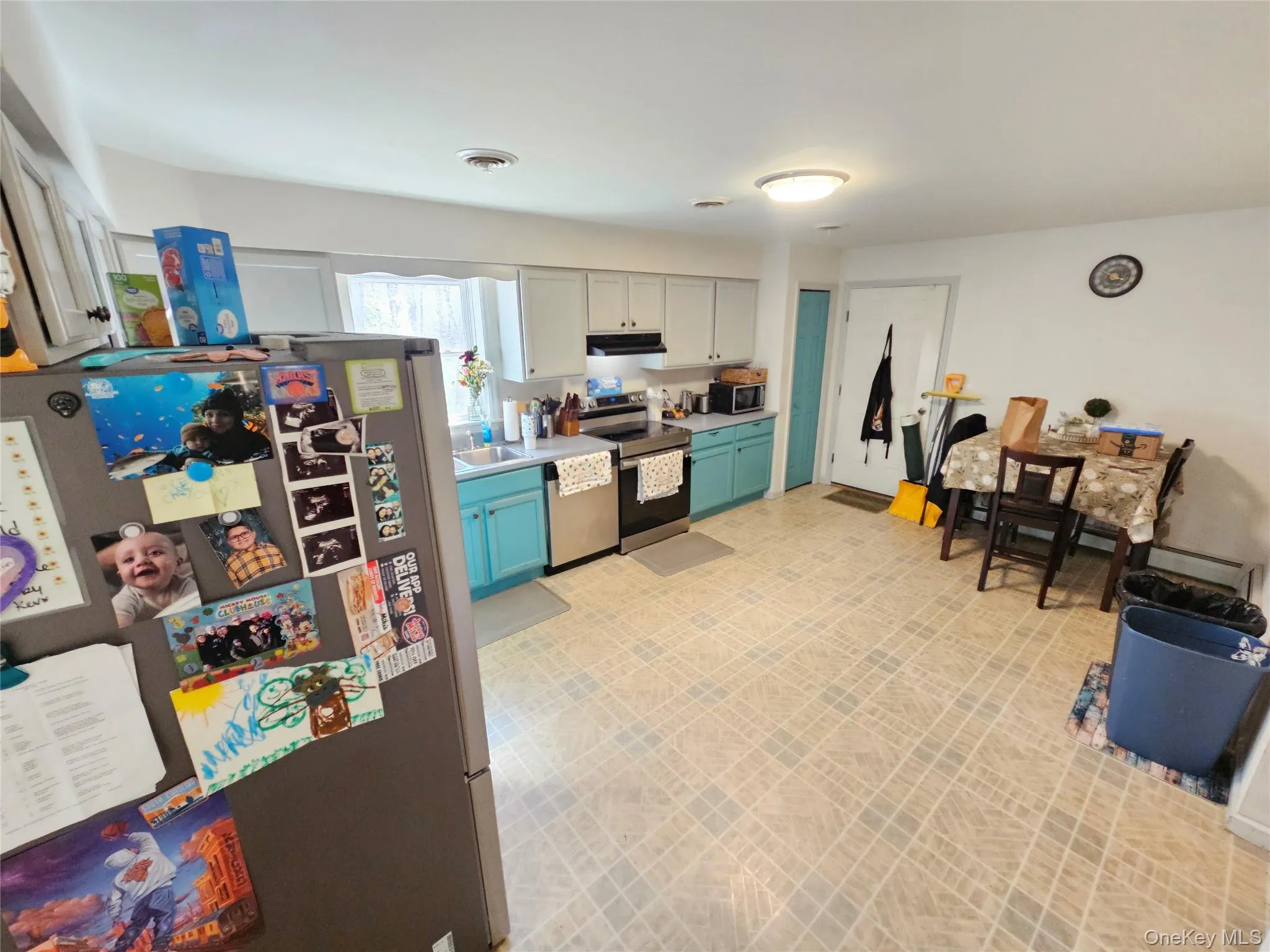 Kitchen featuring stainless steel appliances, light floors, and light countertops Kitchen featuring stainless steel appliances, light floors, and light countertops