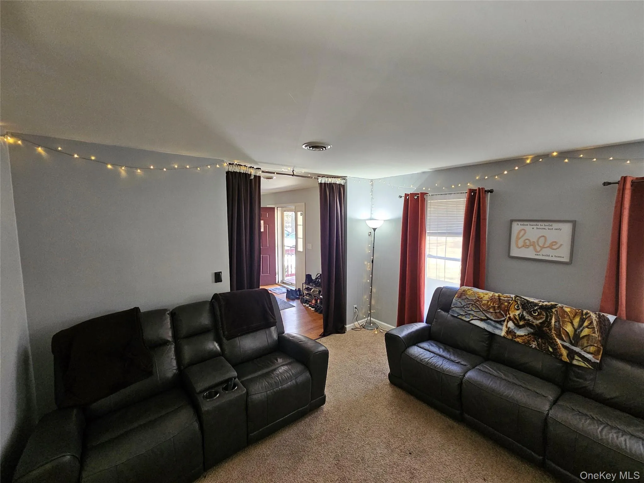 Carpeted living room with baseboards Carpeted living room with baseboards