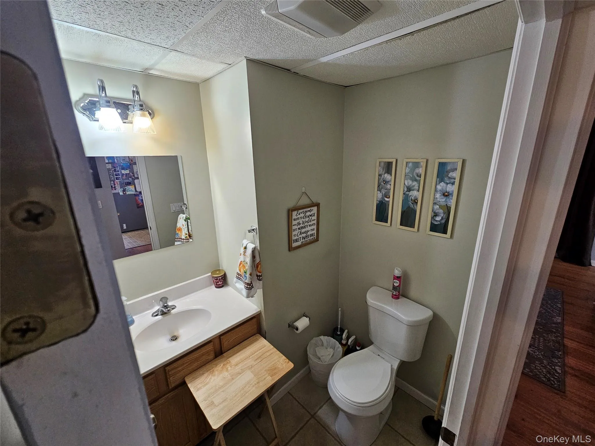 1st Floor Half Bathroom with vanity and dark tile patterned flooring 1st Floor Half Bathroom with vanity and dark tile patterned flooring