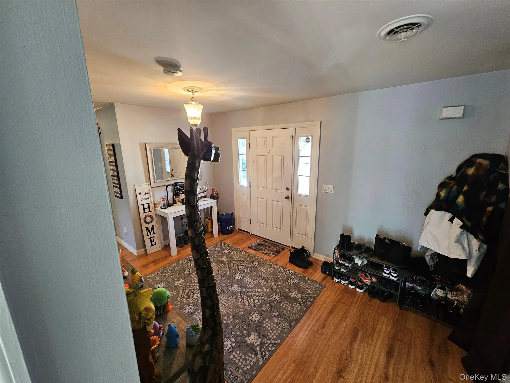 Foyer featuring wood finished floors and baseboards Foyer featuring wood finished floors and baseboards