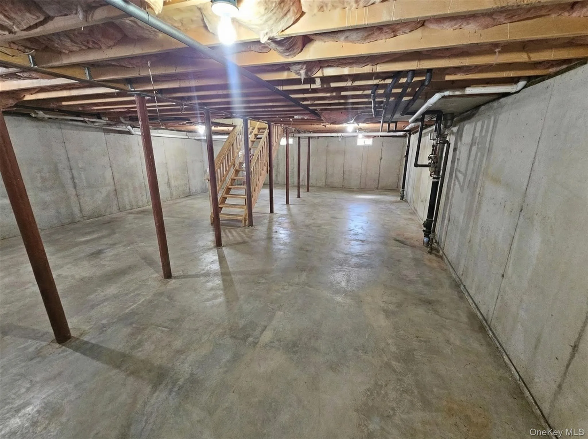 AI Generated - Unfinished basement featuring stairway & utilities. AI Generated - Unfinished basement featuring stairway & utilities.