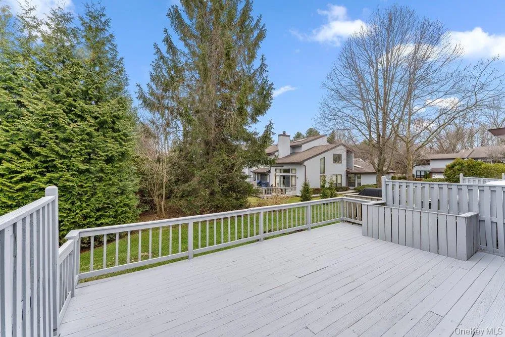 Wooden deck with a lawn and a residential view Wooden deck with a lawn and a residential view