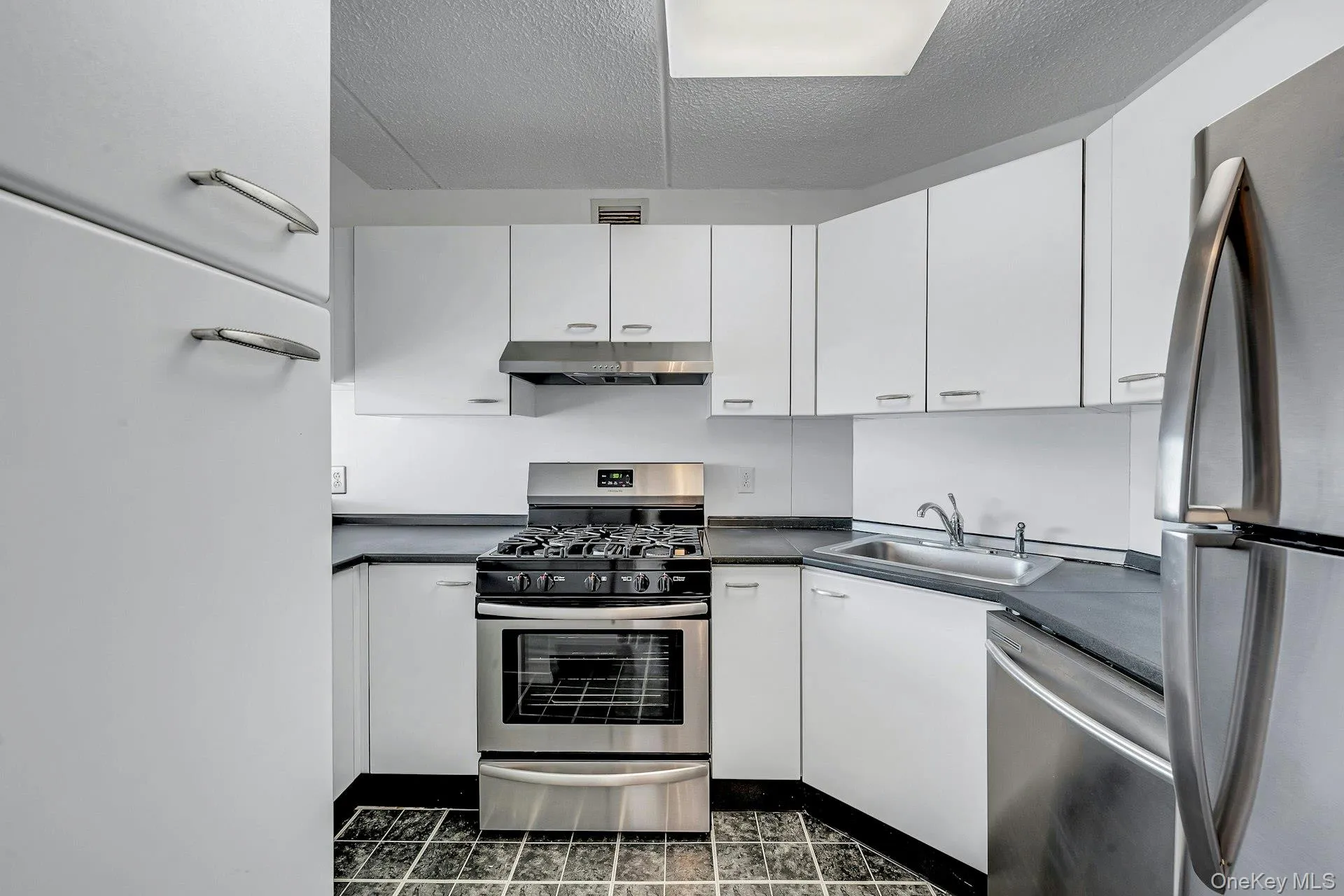 Kitchen has lots of cabinets. Kitchen has lots of cabinets.