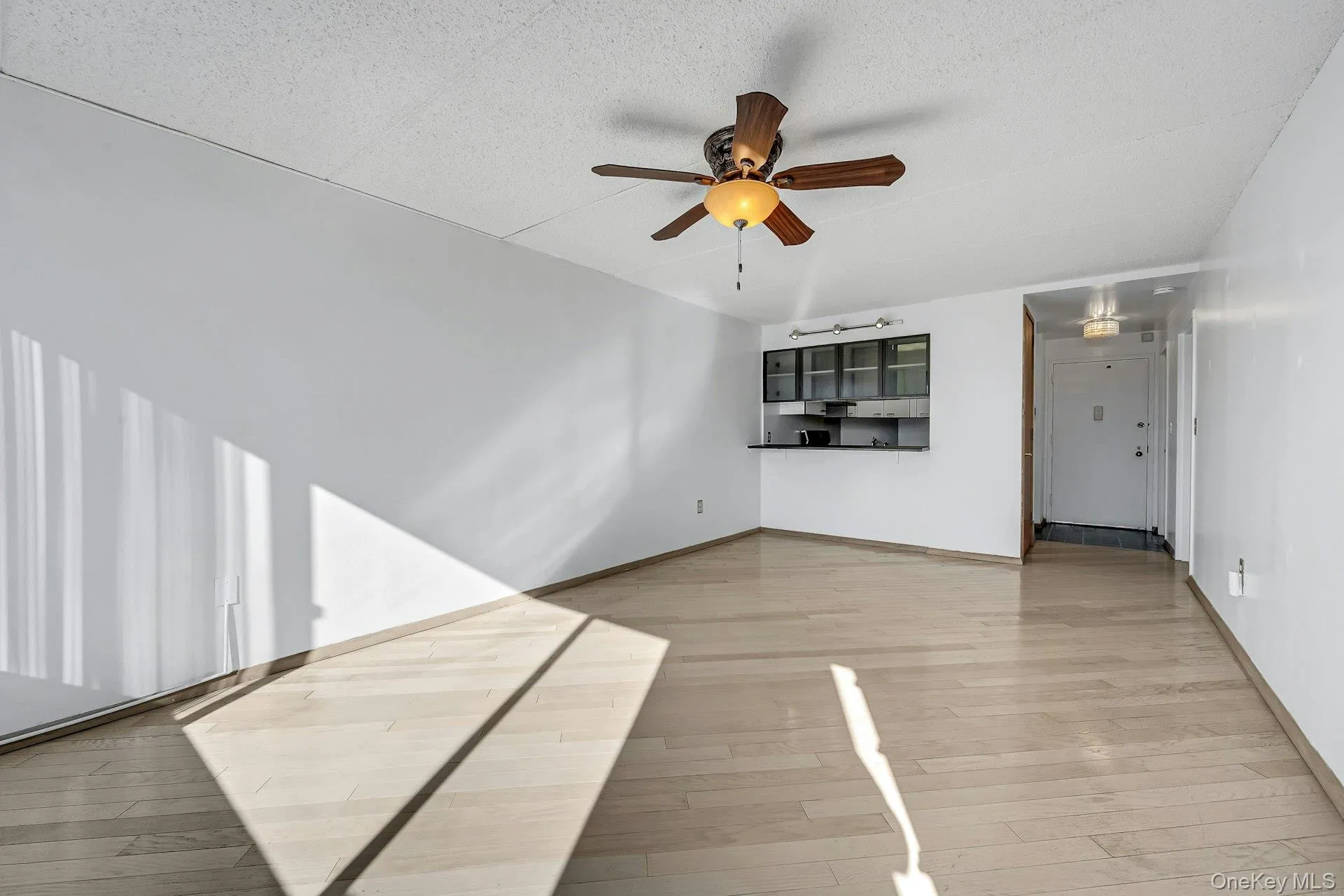 Living Room angle showing breakfast bar and space for a dining table. Living Room angle showing breakfast bar and space for a dining table.