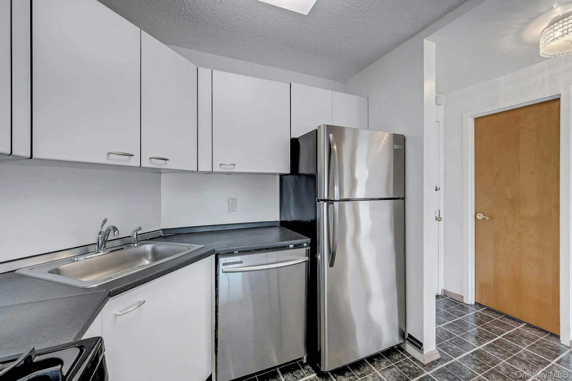 Kitchen view toward entry. Kitchen view toward entry.