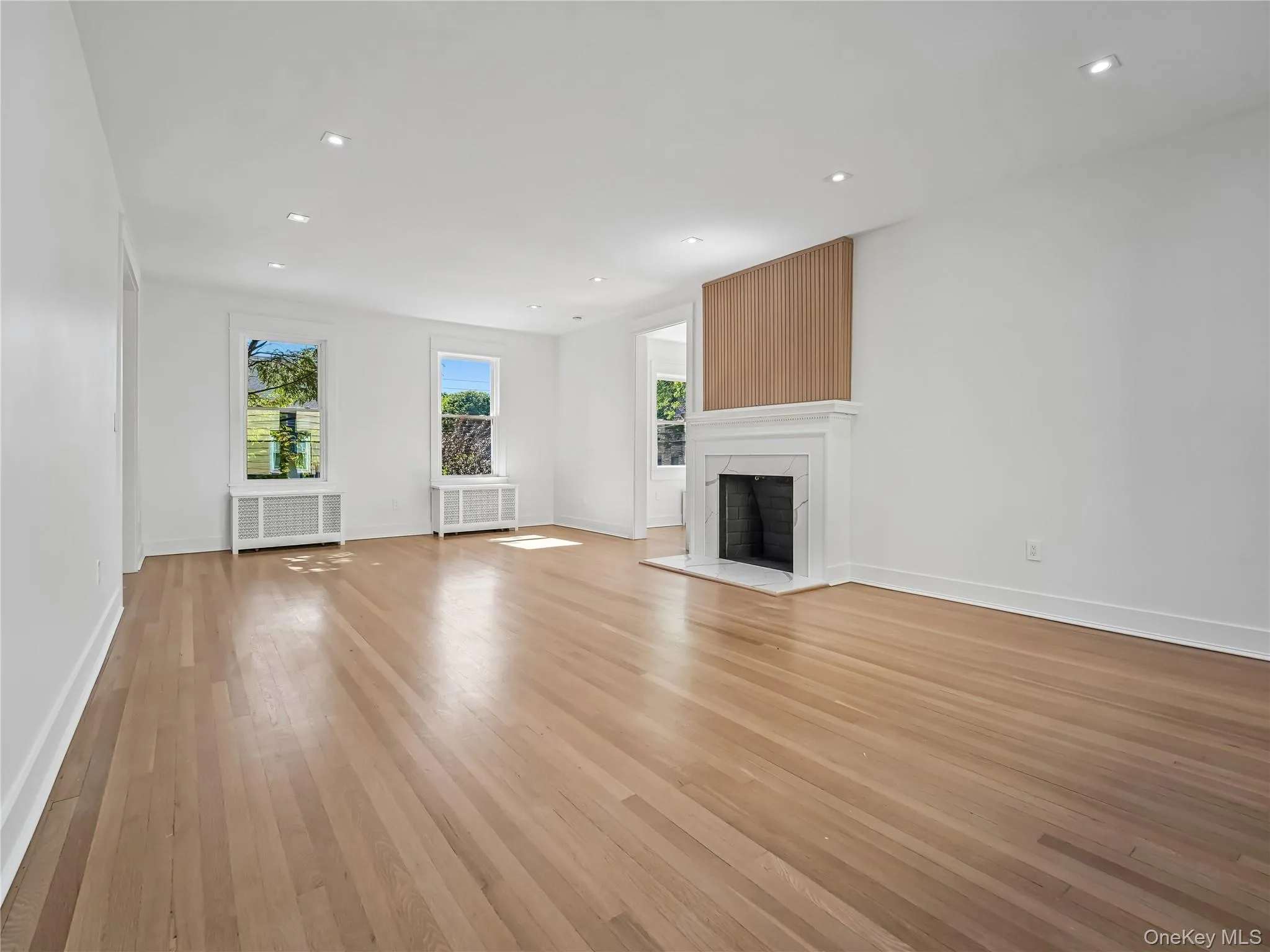 Massive living room with wood fireplace, walls of brand-new windows; all new lighting, plumbing, electric, insulation and split unit. Massive living room with wood fireplace, walls of brand-new windows; all new lighting, plumbing, electric, insulation and split unit.