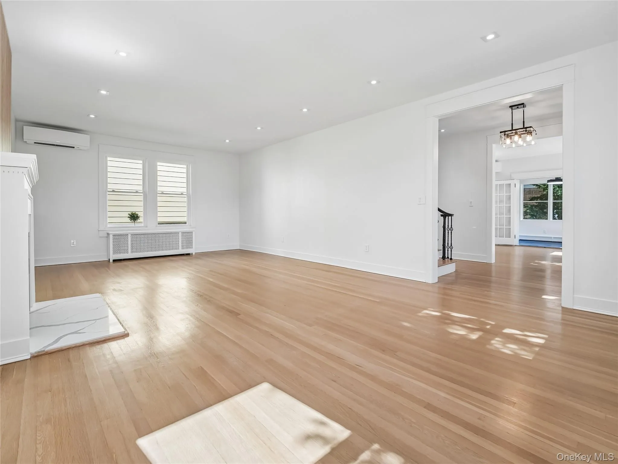 Massive living room with wood fireplace, walls of brand-new windows; all new lighting, plumbing, electric, insulation and split unit. Massive living room with wood fireplace, walls of brand-new windows; all new lighting, plumbing, electric, insulation and split unit.