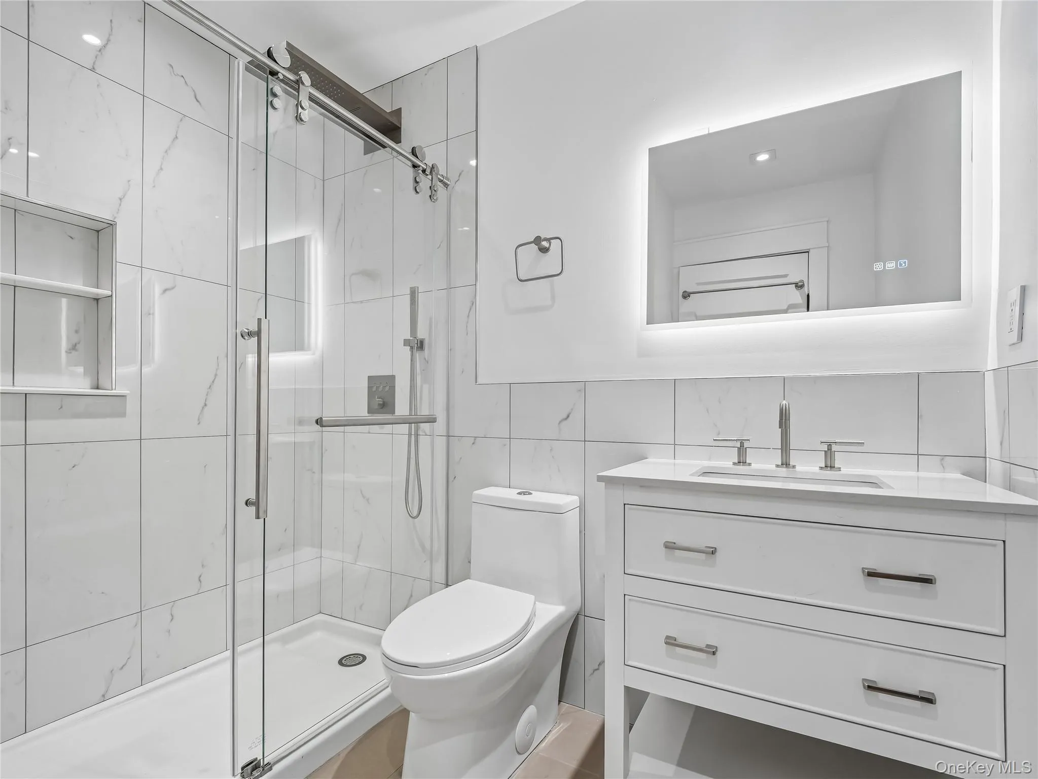 Fully remodeled first floor full bathroom with glass-enclosed shower; all new flooring, lighting, plumbing, and electric. Fully remodeled first floor full bathroom with glass-enclosed shower; all new flooring, lighting, plumbing, and electric.