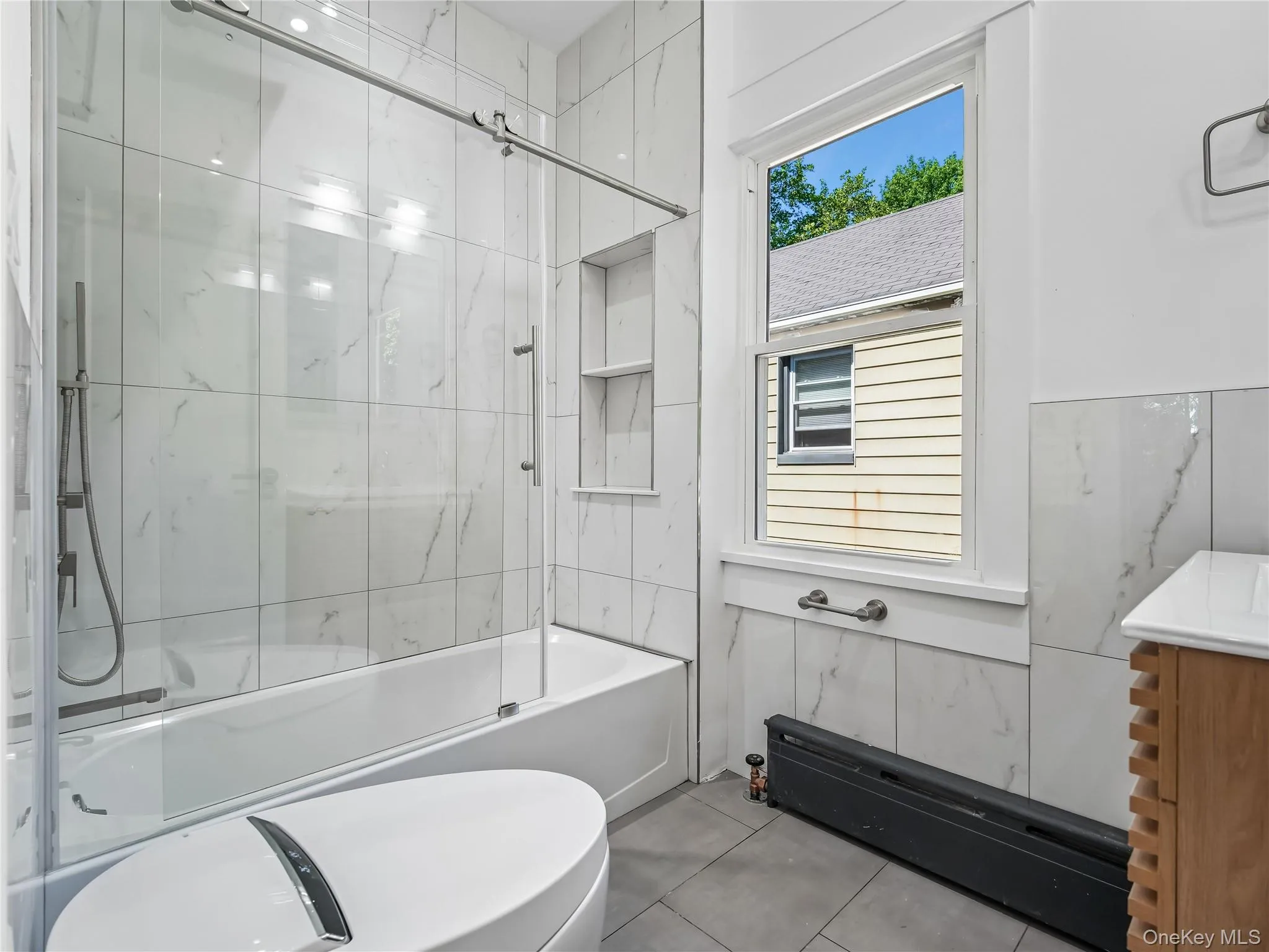 Fully remodeled full bathroom with glass door bathtub/shower and bidet toilet; all new flooring, plumbing, electric, window and insulation. Fully remodeled full bathroom with glass door bathtub/shower and bidet toilet; all new flooring, plumbing, electric, window and insulation.