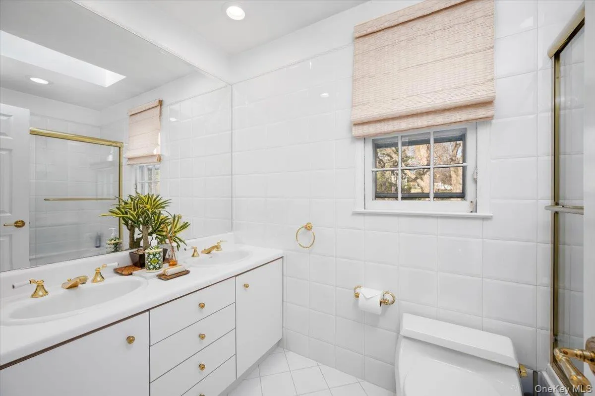 Full bathroom - 1 of 2 total bathrooms on the second floor features two sinks and a tub with shower. Full bathroom - 1 of 2 total bathrooms on the second floor features two sinks and a tub with shower.
