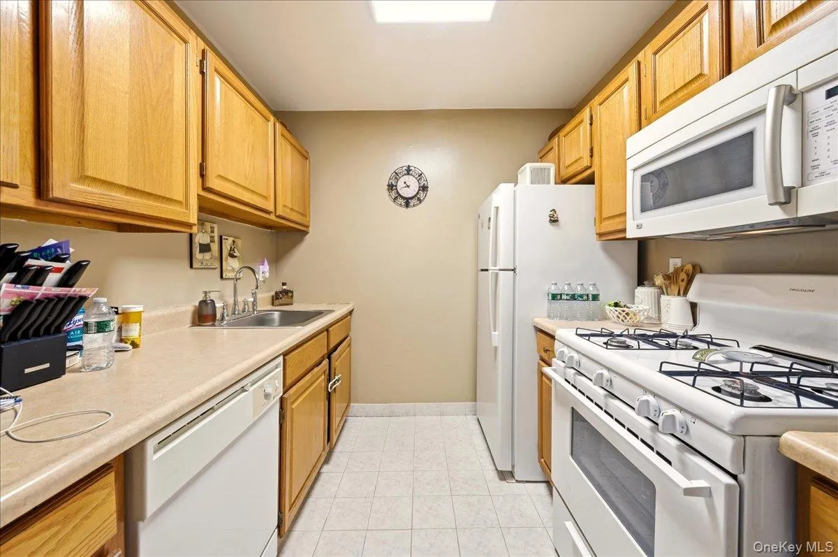 Kitchen featuring white appliances and light countertops Kitchen featuring white appliances and light countertops