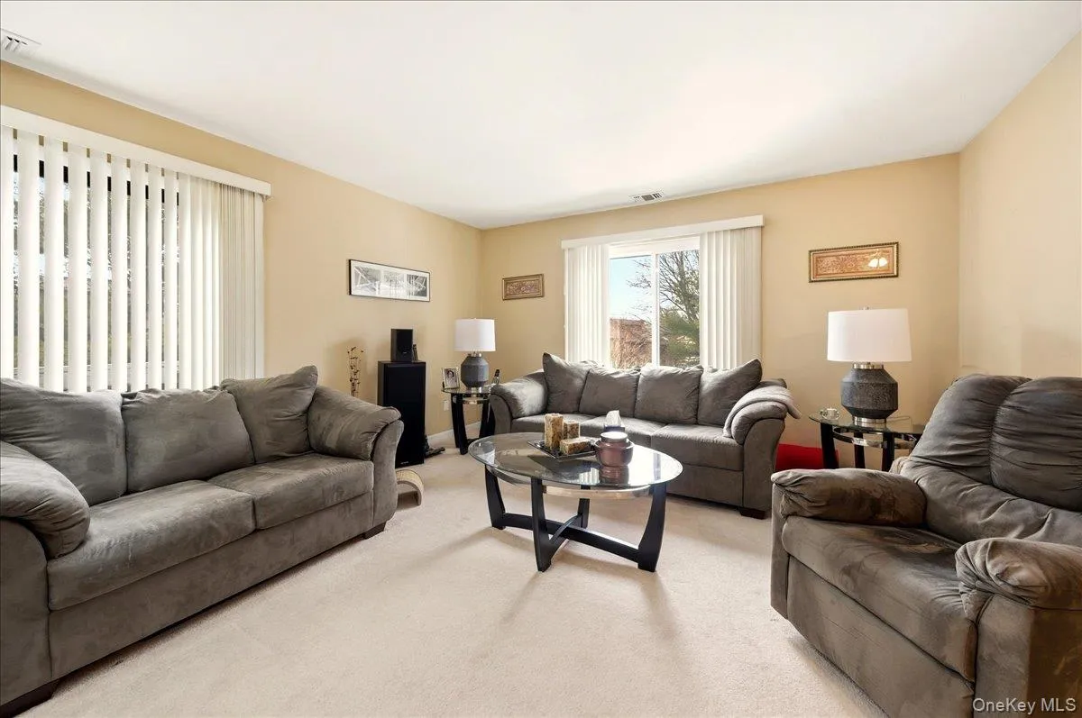 Living area featuring light colored carpet Living area featuring light colored carpet