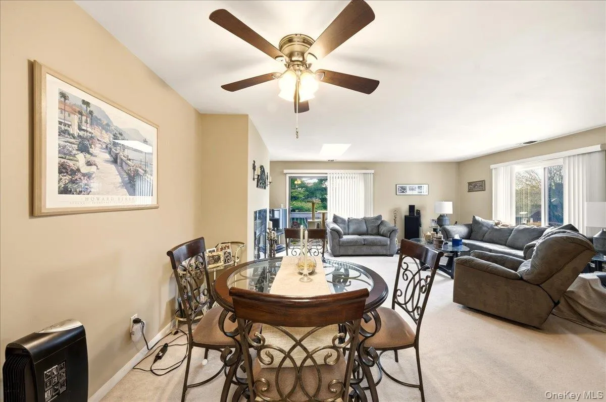 Dining area with light carpet and a ceiling fan Dining area with light carpet and a ceiling fan