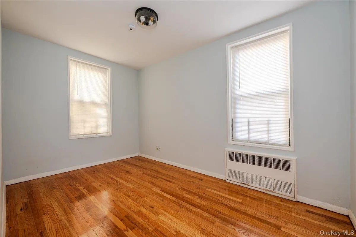 Bedroom room area features fresh paint, new light fixture and polished hardwood floors. Bedroom room area features fresh paint, new light fixture and polished hardwood floors.
