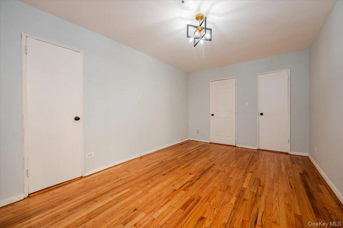 Bedroom room area features fresh paint, new light fixture and polished hardwood floors. Bedroom room area features fresh paint, new light fixture and polished hardwood floors.