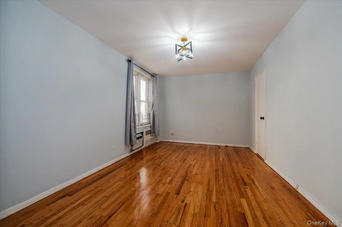 Bedroom room area features fresh paint, new light fixture and polished hardwood floors. Bedroom room area features fresh paint, new light fixture and polished hardwood floors.