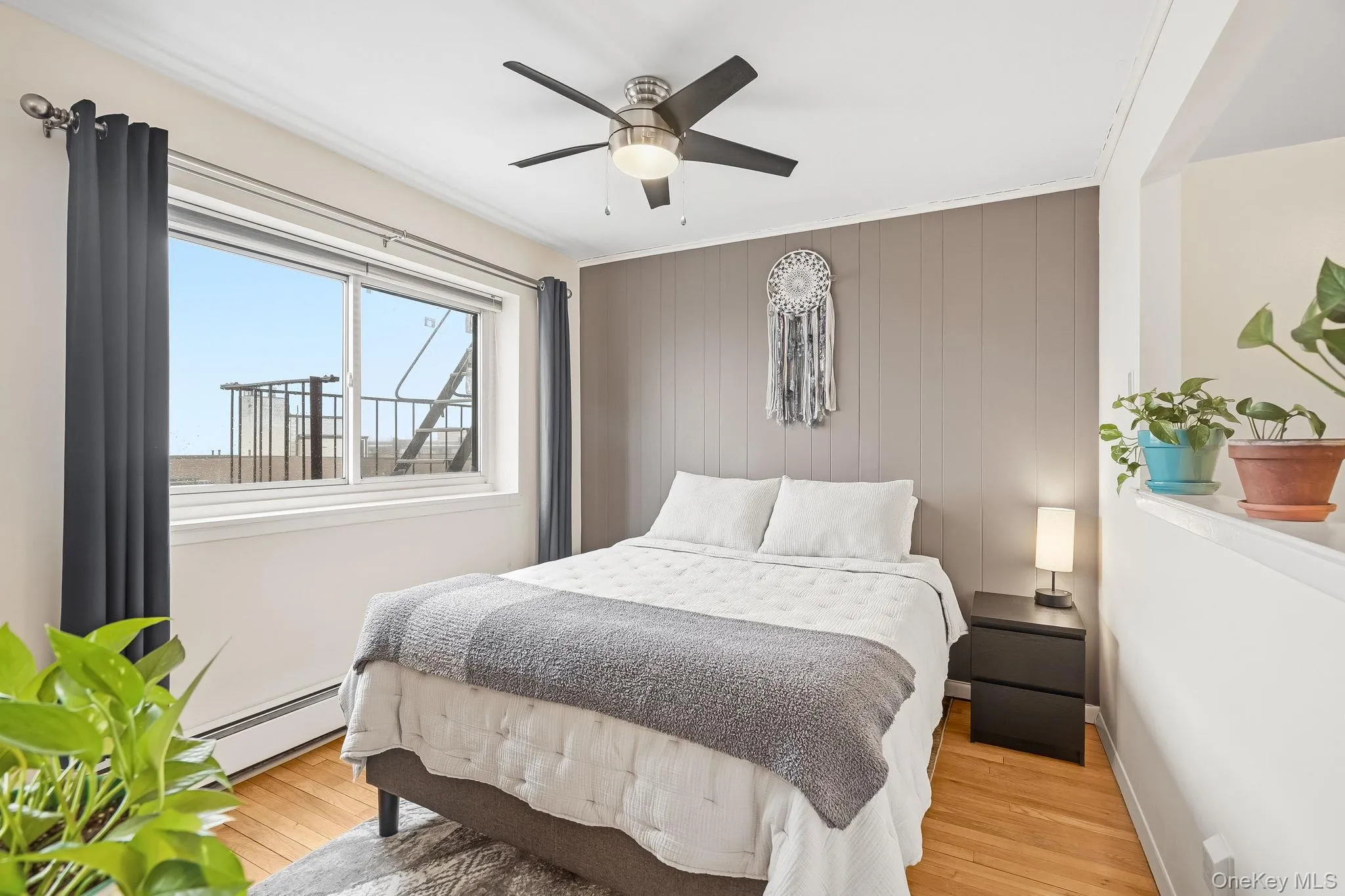 The Bedroom area with a ceiling fan and another large window that lets in a lot of sunlight The Bedroom area with a ceiling fan and another large window that lets in a lot of sunlight