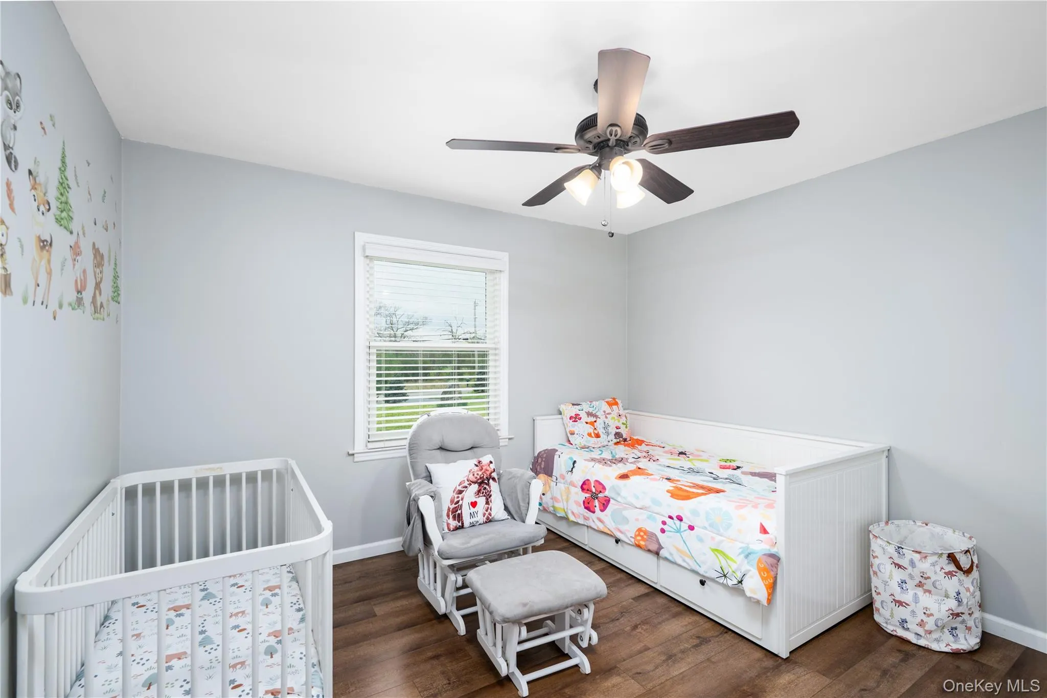 Bedroom 1-featuring wood-flooring, a single window with blinds, and a ceiling fan with integrated lighting Bedroom 1-featuring wood-flooring, a single window with blinds, and a ceiling fan with integrated lighting