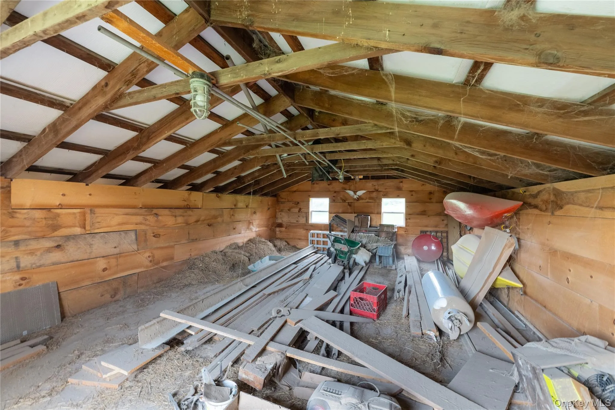 Interior Red Barn, upper hayloft with equipment for horse stalls Interior Red Barn, upper hayloft with equipment for horse stalls