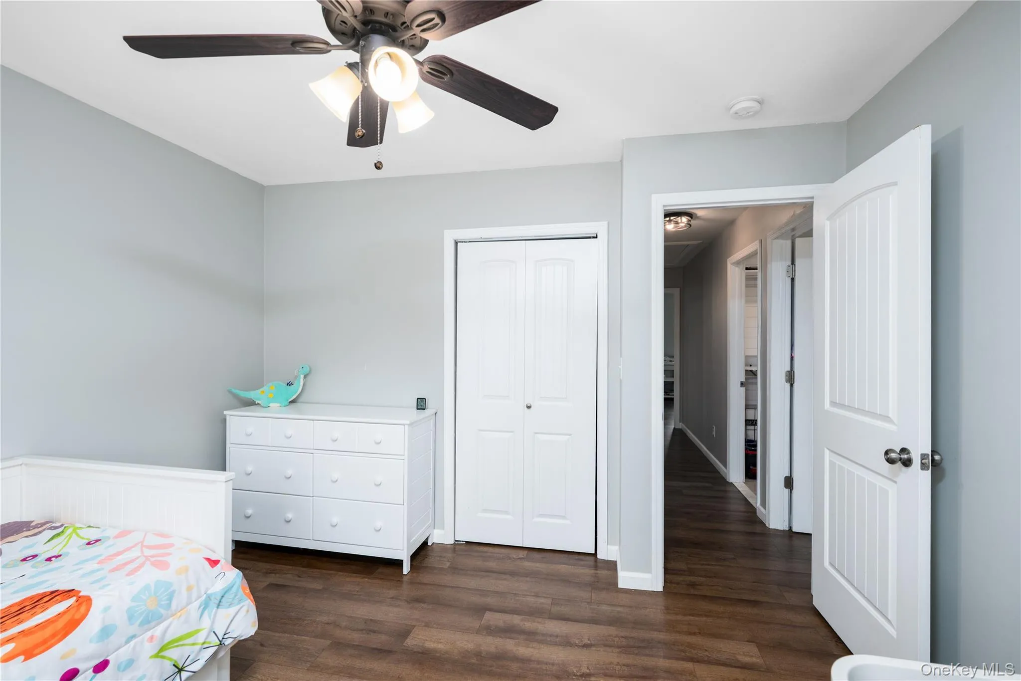 Bedroom 1-featuring wood-flooring, light gray wall paint, and a ceiling fan with integrated lighting Bedroom 1-featuring wood-flooring, light gray wall paint, and a ceiling fan with integrated lighting