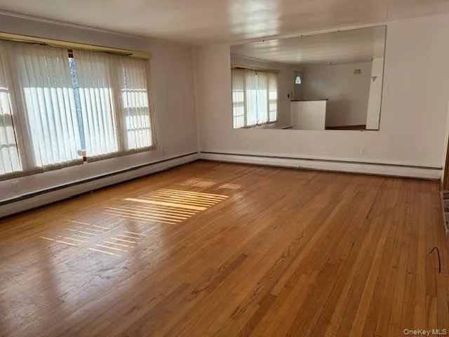 Expansive living room connecting front door to dining area, kitchen, and stairs to bedrooms Expansive living room connecting front door to dining area, kitchen, and stairs to bedrooms