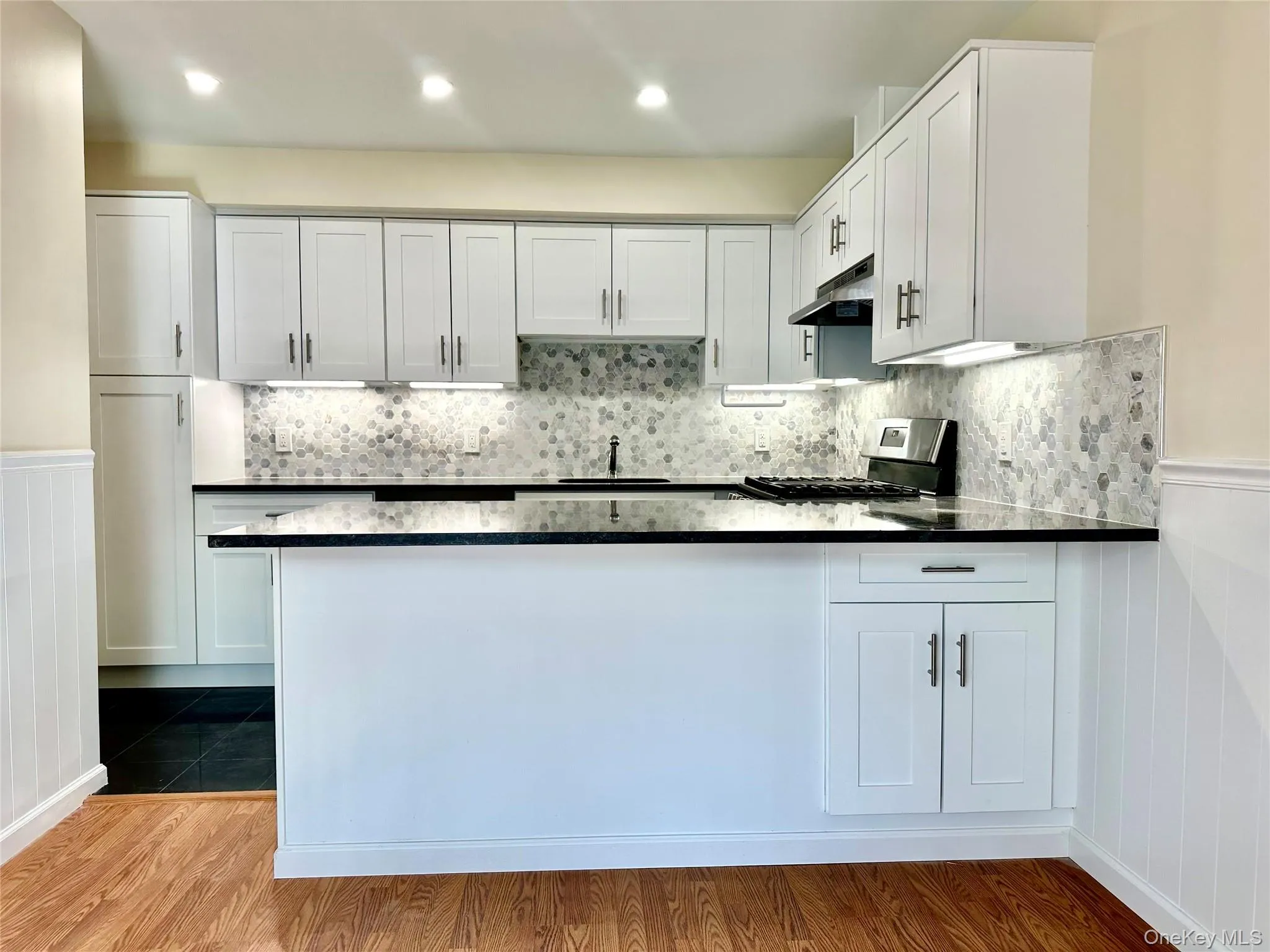 Kitchen installed in 2025 with white cabinets and SS appliances and and isle-like seating area. Kitchen installed in 2025 with white cabinets and SS appliances and and isle-like seating area.