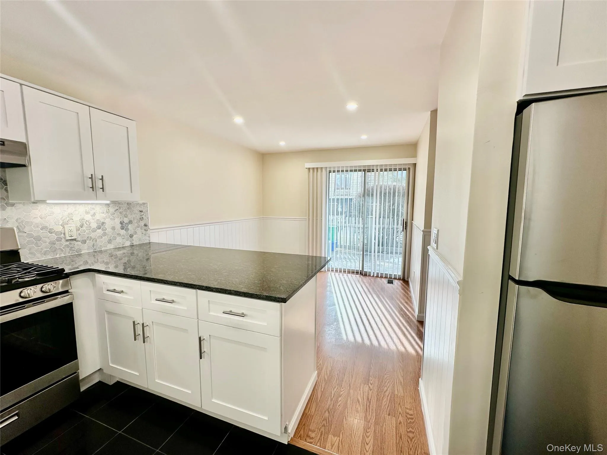 Kitchen installed in 2025 with white cabinets and SS appliances and and isle-like seating area. Kitchen installed in 2025 with white cabinets and SS appliances and and isle-like seating area.