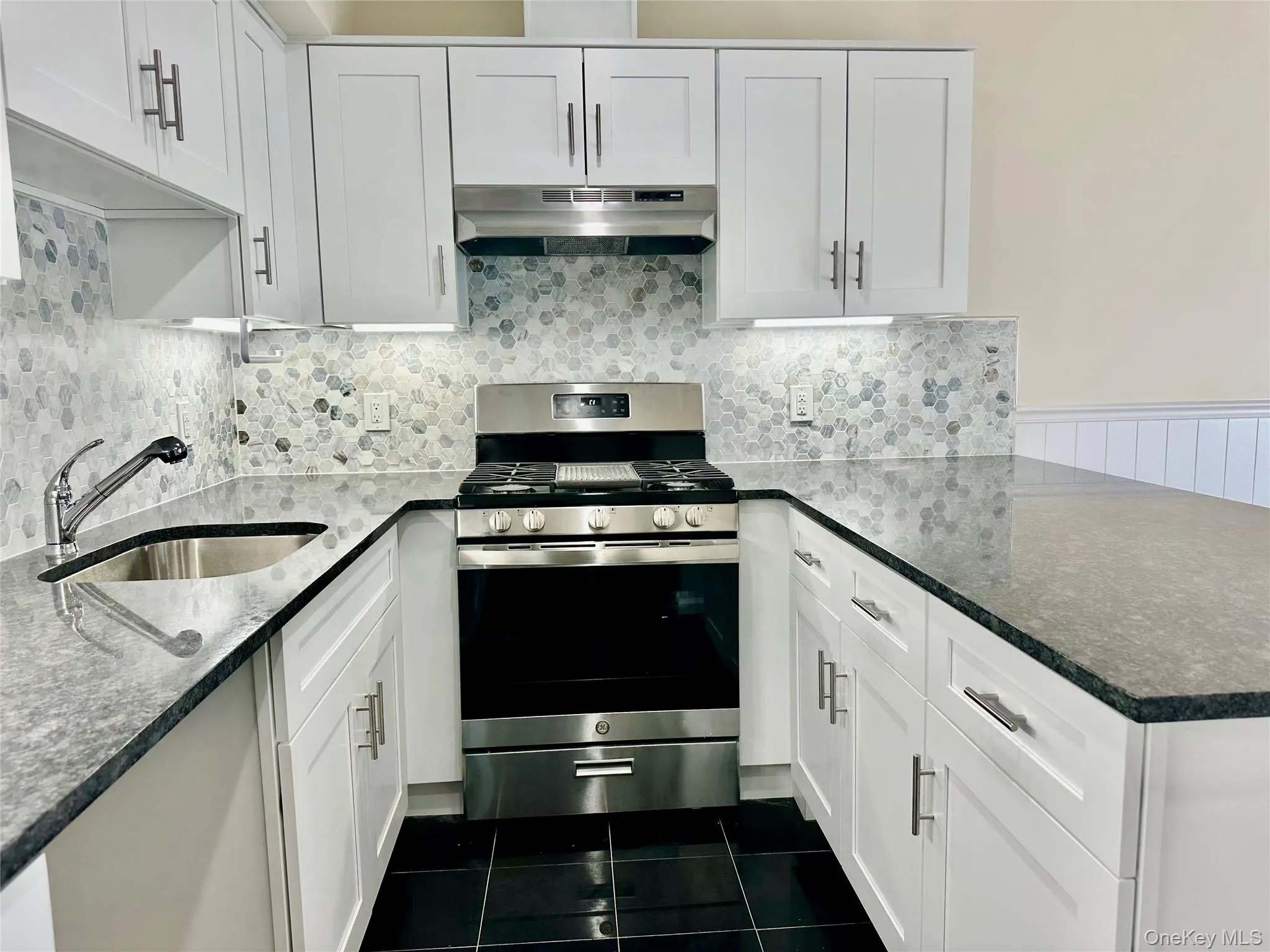 Kitchen installed in 2025with white cabinets and SS appliances and and isle-like seating area. Kitchen installed in 2025with white cabinets and SS appliances and and isle-like seating area.