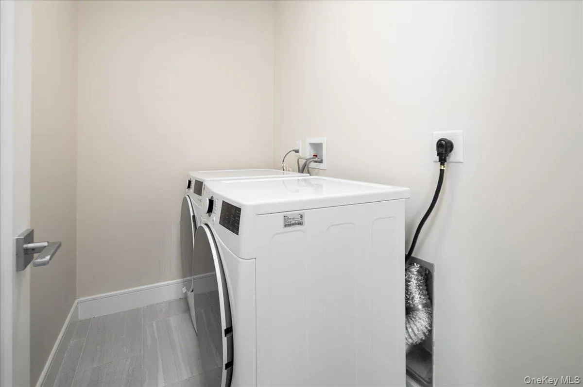 Laundry room with baseboards, washing machine and dryer, and laundry area Laundry room with baseboards, washing machine and dryer, and laundry area