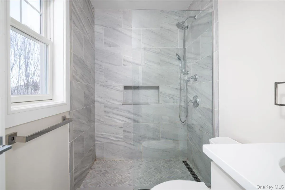 Full bathroom with toilet, vanity, and a shower stall Full bathroom with toilet, vanity, and a shower stall