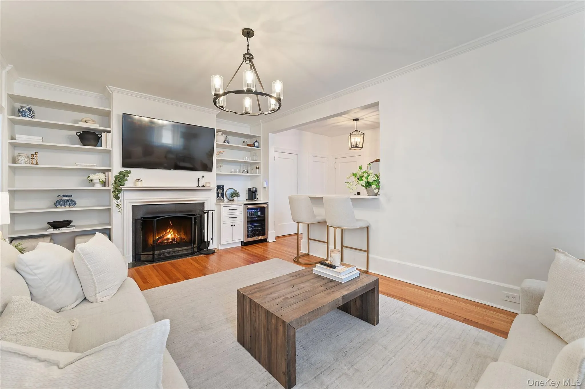Living Room features a wood burning fireplace with built-ins and beverage refrigerator. Living Room features a wood burning fireplace with built-ins and beverage refrigerator.
