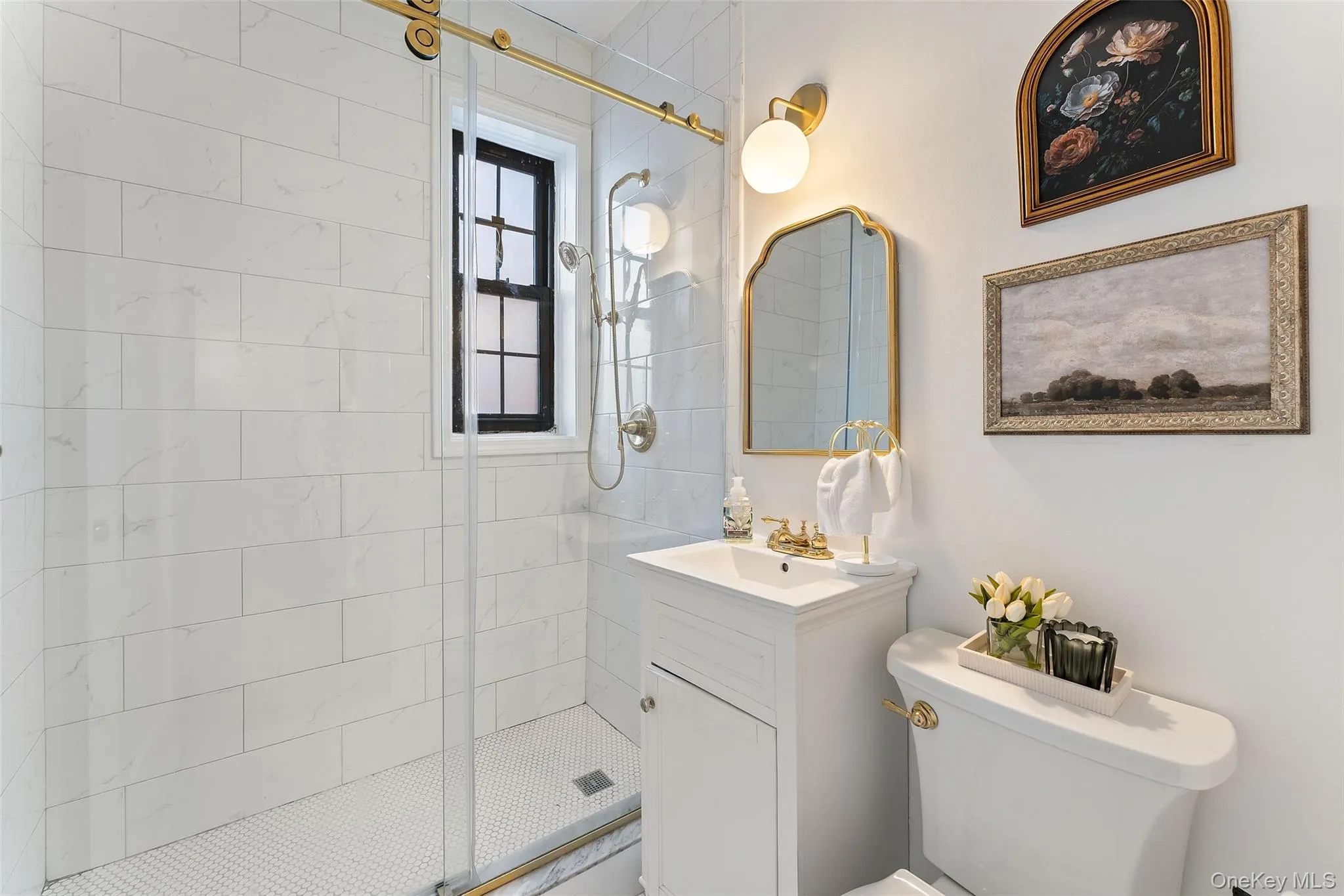 Fully renovated bathroom featuring a glass shower door. Fully renovated bathroom featuring a glass shower door.