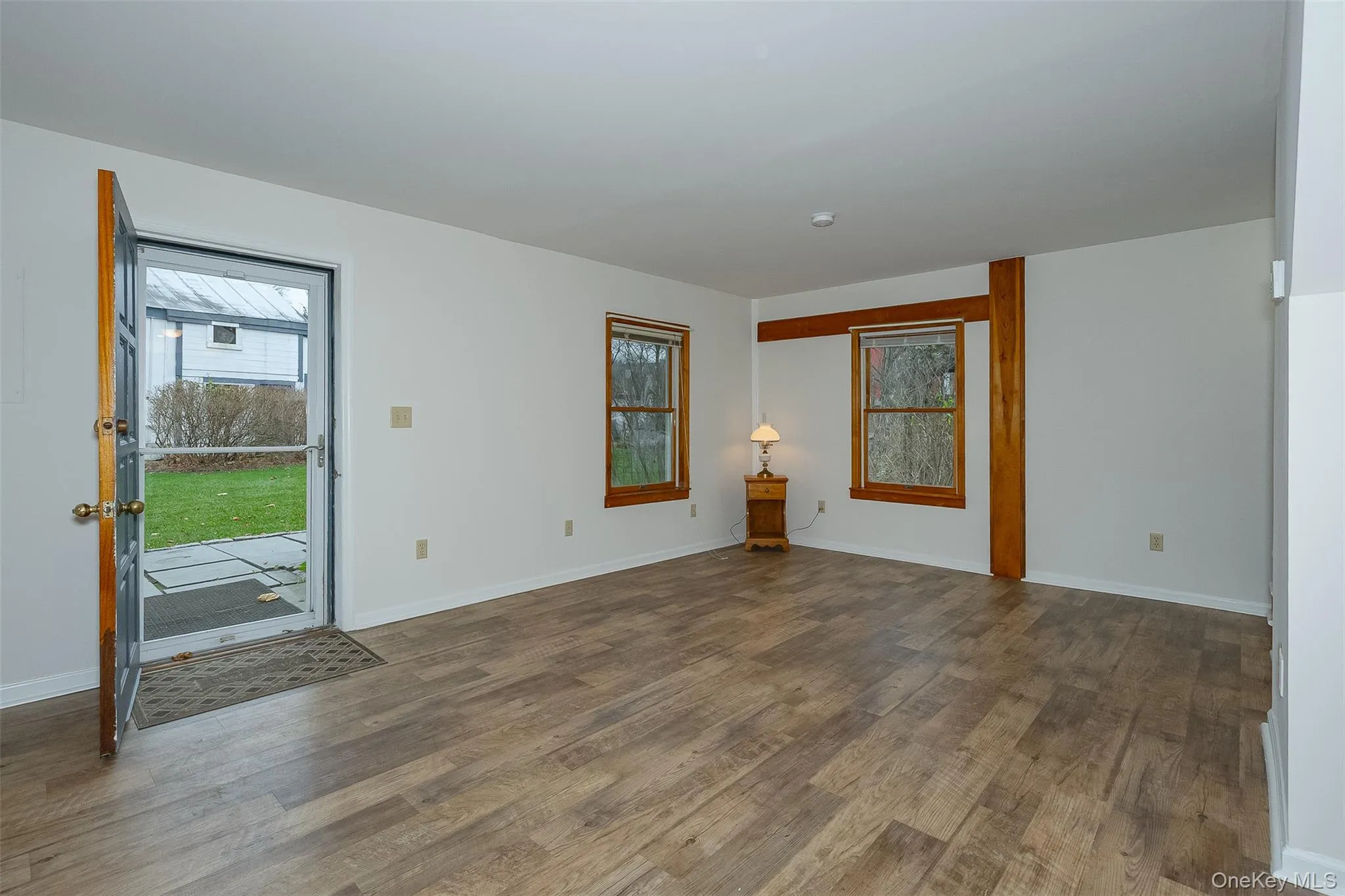 Empty room featuring dark wood-type flooring and baseboards Empty room featuring dark wood-type flooring and baseboards