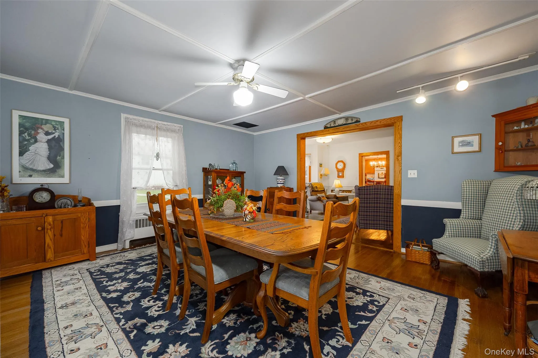 Dining area with wood finished floors, ceiling fan, and ornamental molding Dining area with wood finished floors, ceiling fan, and ornamental molding