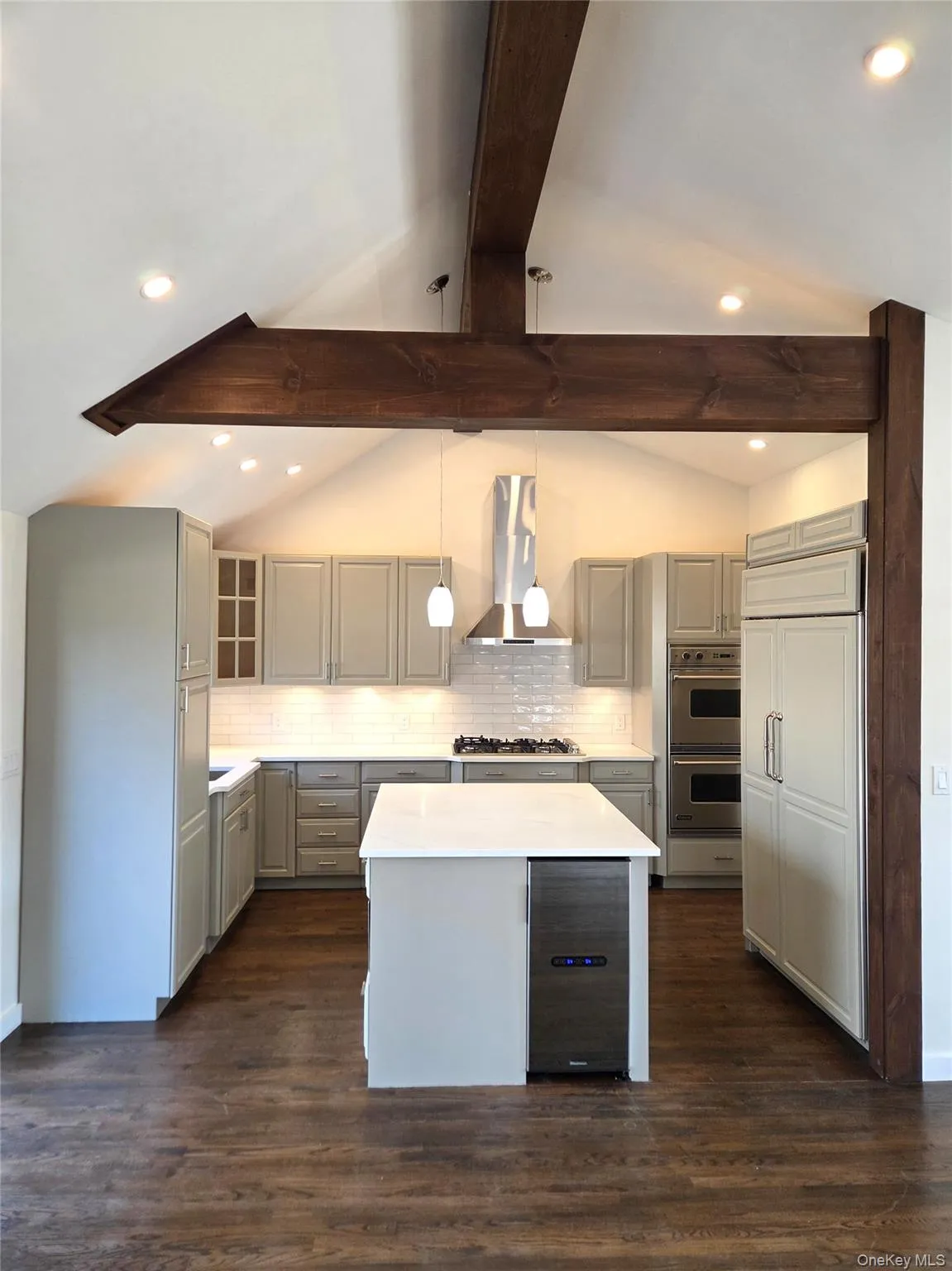 The Stunning Chef's Kitchen Offers Magnificent Beamed Ceilings, Three Rows Of Custom Raised Panel Grey Cabinetry, Subway Tiled Backsplash, Built In Pantry, Ample Cabinetry/Storage, Vikio Stainless Steel Range Hood, Sub Zero Refrigerator, Viking Built In Double Oven & Thor 18,000 BTU 6 Burner Gas Cooktop. The Stunning Chef's Kitchen Offers Magnificent Beamed Ceilings, Three Rows Of Custom Raised Panel Grey Cabinetry, Subway Tiled Backsplash, Built In Pantry, Ample Cabinetry/Storage, Vikio Stainless Steel Range Hood, Sub Zero Refrigerator, Viking Built In Double Oven & Thor 18,000 BTU 6 Burner Gas Cooktop.