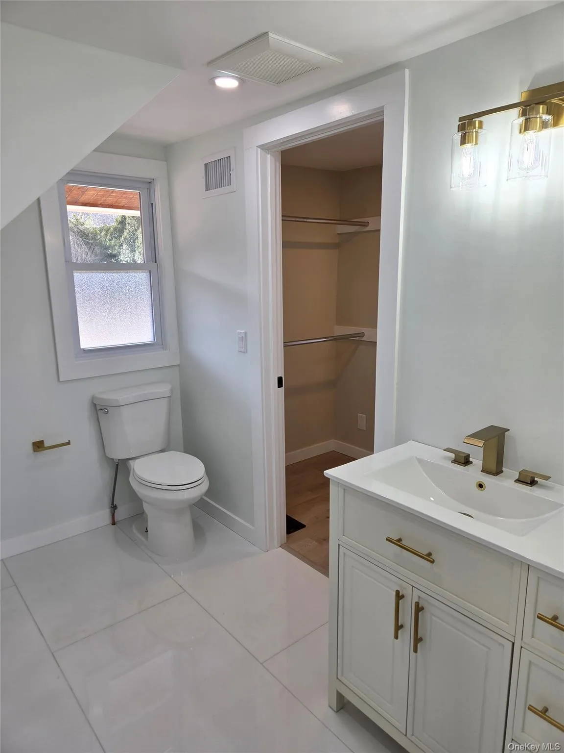 Another View Of The Stunning, Completely Renovated Primary Bathroom Offering 48" x 24' Porcelain Tile Floors, Upgraded Vanity & Fixtures With All Brass Accents, Custom Shower With All Porcelain Tiled Walls & Frameless Glass Doors, And Access To Two Additional Closets/Storage Space Between The Bathroom & The Primary Bedroom. Another View Of The Stunning, Completely Renovated Primary Bathroom Offering 48" x 24' Porcelain Tile Floors, Upgraded Vanity & Fixtures With All Brass Accents, Custom Shower With All Porcelain Tiled Walls & Frameless Glass Doors, And Access To Two Additional Closets/Storage Space Between The Bathroom & The Primary Bedroom.