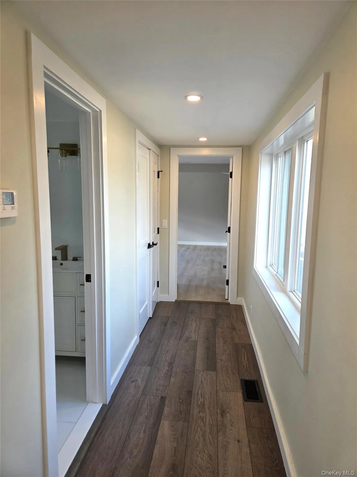 Another View Of The Hallway Leading To The Main Floor Laundry Area, And The Primary Bedroom & Bathroom. Another View Of The Hallway Leading To The Main Floor Laundry Area, And The Primary Bedroom & Bathroom.