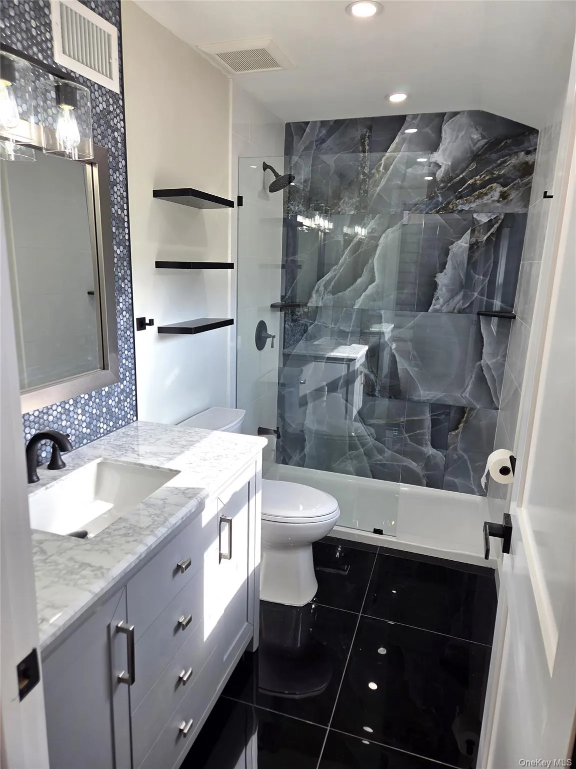 The Stunning, Completely Renovated Guest Bathroom Offers A Full Shower With 48" x 24" Accent Porcelain Tiled Walls, Frameless Glass Door & Beautiful Tilework, 24" Porcelain Tile Floor, Custom Vanity & All Upgraded/Modern Features. The Stunning, Completely Renovated Guest Bathroom Offers A Full Shower With 48" x 24" Accent Porcelain Tiled Walls, Frameless Glass Door & Beautiful Tilework, 24" Porcelain Tile Floor, Custom Vanity & All Upgraded/Modern Features.