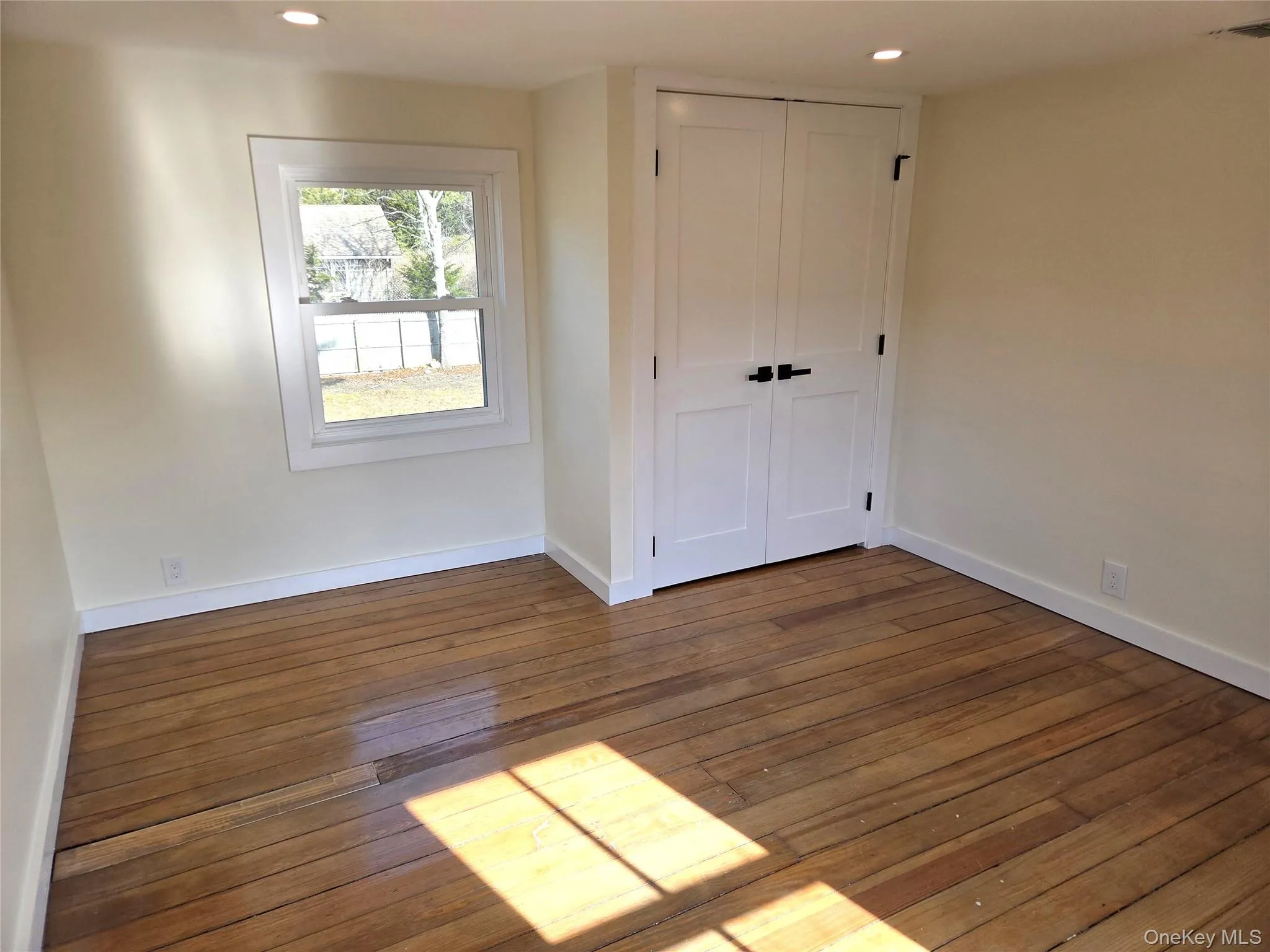 Another View Of The Well Sized Second Bedroom Offering Original Wide Plank Wood Floors, Lots Of Windows For Natural Light, Recessed Lighting & A Double Sized Closet. Another View Of The Well Sized Second Bedroom Offering Original Wide Plank Wood Floors, Lots Of Windows For Natural Light, Recessed Lighting & A Double Sized Closet.